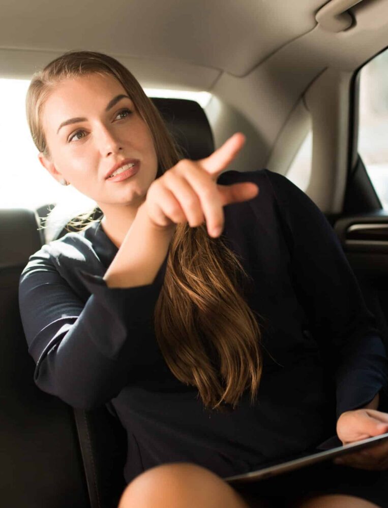 femme dans un taxi qui montre la direction